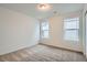 Cozy bedroom with neutral carpet, ample natural light from two windows, and a closet for storage at 7199 Waterleaf Trl, Littleton, CO 80125