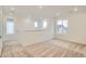 Large bonus room with neutral carpet, recessed lighting, a railing, and ample natural light from several windows at 7199 Waterleaf Trl, Littleton, CO 80125