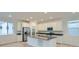 Modern kitchen with stainless steel appliances, island sink, and hardwood floors at 7199 Waterleaf Trl, Littleton, CO 80125