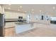 Open-concept kitchen with stainless appliances, island sink, and seamless flow to living area at 7199 Waterleaf Trl, Littleton, CO 80125