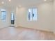 Bright living room showcasing hardwood floors, recessed lighting, and large windows at 7199 Waterleaf Trl, Littleton, CO 80125