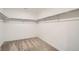 Spacious walk-in closet with carpeting and ample storage with shelving on all sides at 7199 Waterleaf Trl, Littleton, CO 80125