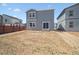 Wide shot of a spacious backyard with a modern home and a wood fence, perfect for outdoor enjoyment at 2222 Flower Blossom Ave, Brighton, CO 80601