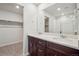 Bathroom featuring a double sink vanity with sleek cabinets, a large mirror and a shower at 2222 Flower Blossom Ave, Brighton, CO 80601