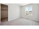 Bright bedroom with neutral carpet and walls, closet space, and neighborhood views at 2222 Flower Blossom Ave, Brighton, CO 80601