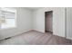 Bright bedroom with natural light, neutral carpet and walls, and closet for ample storage at 2222 Flower Blossom Ave, Brighton, CO 80601