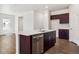 Modern kitchen with white countertops, stainless steel dishwasher, and dark wood cabinetry at 2222 Flower Blossom Ave, Brighton, CO 80601