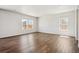 Bright open living room with luxury vinyl flooring, large windows and neutral walls at 2222 Flower Blossom Ave, Brighton, CO 80601