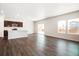 Spacious living area with wood floors, large windows for natural light, and open floor plan at 2222 Flower Blossom Ave, Brighton, CO 80601
