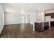 Open living space featuring wood floors, recessed lighting, and an integrated kitchen at 2222 Flower Blossom Ave, Brighton, CO 80601