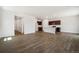 Open-concept living space featuring wood floors and seamless flow to kitchen and hallways at 2222 Flower Blossom Ave, Brighton, CO 80601