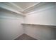 Walk-in closet features clean, neutral walls and carpet, and chrome organizers for optimized storage solutions at 13583 E 103Rd Ave, Commerce City, CO 80022