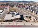 Aerial view of community amenities including pool, playground and fitness facility with mountain backdrop at 15818 W 95Th Ave, Arvada, CO 80007
