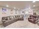 Spacious finished basement with a wet bar, seating area and decorative mountain ski posters at 15818 W 95Th Ave, Arvada, CO 80007