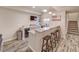 Basement bar featuring a granite countertop, wooden stools, and decorative touches at 15818 W 95Th Ave, Arvada, CO 80007