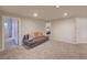 Spacious finished basement with neutral colors, recessed lights, and access to other rooms at 15818 W 95Th Ave, Arvada, CO 80007