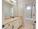Bright bathroom with a vanity and a mirror, leading to a tiled shower and bathtub combo at 15818 W 95Th Ave, Arvada, CO 80007