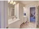 Bathroom featuring dual vanities, tiled floors, and a doorway leading to the bedroom at 15818 W 95Th Ave, Arvada, CO 80007