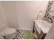 Powder room with black and white tiled floor and a modern vanity with a patterned backsplash at 15818 W 95Th Ave, Arvada, CO 80007
