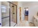 Elegant bathroom with a glass-enclosed shower and well-organized walk-in closet at 15818 W 95Th Ave, Arvada, CO 80007
