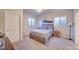 Comfortable bedroom with carpet flooring, light walls, and a decorative bed frame beneath a modern light fixture at 15818 W 95Th Ave, Arvada, CO 80007