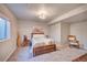 Carpeted bedroom with a queen-sized bed, a nightstand, and an accent chair at 15818 W 95Th Ave, Arvada, CO 80007