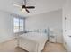 Bedroom with a queen-sized bed, ceiling fan, natural light, and a small desk next to the window at 15818 W 95Th Ave, Arvada, CO 80007