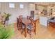 Dining area adjacent to a modern kitchen, with wood floors and bright, natural light at 15818 W 95Th Ave, Arvada, CO 80007