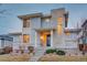 Modern two-story home with stone accents, large windows, and a well-manicured front yard at 15818 W 95Th Ave, Arvada, CO 80007
