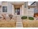 Charming home featuring a welcoming front entrance with stone accents and landscaped pathway at 15818 W 95Th Ave, Arvada, CO 80007