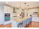 Modern kitchen with stainless steel appliances, granite countertops, and a spacious island with seating at 15818 W 95Th Ave, Arvada, CO 80007