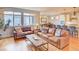 Cozy living room with hardwood floors, comfortable leather sofas, and seamless access to the kitchen at 15818 W 95Th Ave, Arvada, CO 80007