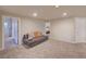 Spacious carpeted living room with neutral tones, recessed lighting, and multiple doorways at 15818 W 95Th Ave, Arvada, CO 80007