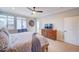 Bright main bedroom with a large window, dresser, and access to the outdoor patio at 15818 W 95Th Ave, Arvada, CO 80007