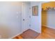 Mud room features a light grey wall with a coat rack, a door, and access to an open closet space for storage at 15818 W 95Th Ave, Arvada, CO 80007