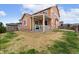 Backyard featuring green grass, a covered patio, and a wooden deck at 3081 Youngheart Way, Castle Rock, CO 80109