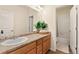 Bright bathroom with wood cabinets, sink, mirror, light fixture and neutral paint at 3081 Youngheart Way, Castle Rock, CO 80109