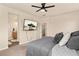 Bedroom with big windows, carpet flooring, a ceiling fan, and a TV mounted on the wall at 3081 Youngheart Way, Castle Rock, CO 80109