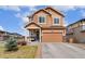 Inviting two-story home with a well-maintained lawn, covered porch, and an attached two-car garage at 3081 Youngheart Way, Castle Rock, CO 80109