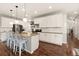 Bright kitchen featuring white cabinets, granite countertops, stainless steel appliances, and hardwood flooring at 3081 Youngheart Way, Castle Rock, CO 80109