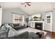 Inviting living room with a fireplace, large TV, comfortable seating, and ample natural light from big windows at 3081 Youngheart Way, Castle Rock, CO 80109