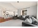 Spacious living room showcasing an open concept layout with a view of the modern kitchen and a comfortable sectional sofa at 3081 Youngheart Way, Castle Rock, CO 80109