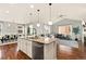 Open-concept living space, kitchen island, dining area and cozy living room with fireplace; perfect for modern living at 3081 Youngheart Way, Castle Rock, CO 80109