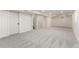 This basement features neutral carpet, recessed lighting, white walls and trim, and two access doors at 6448 Ingalls Ct, Arvada, CO 80003
