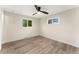 This bedroom features wood floors, white walls, modern ceiling fan, and windows with lots of natural light at 6448 Ingalls Ct, Arvada, CO 80003