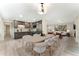 Open concept dining room and kitchen with stainless appliances and modern light fixture at 6448 Ingalls Ct, Arvada, CO 80003