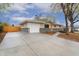 Ranch-style home featuring an attached garage and a concrete driveway at 6448 Ingalls Ct, Arvada, CO 80003