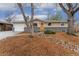 Charming ranch home with a well-manicured front yard and inviting yellow front door at 6448 Ingalls Ct, Arvada, CO 80003