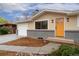 Inviting ranch-style home with a bright yellow front door and attached garage at 6448 Ingalls Ct, Arvada, CO 80003