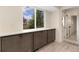 Kitchen cabinets with stainless hardware and a large window at 6448 Ingalls Ct, Arvada, CO 80003